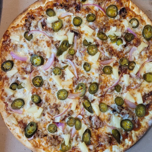 Dontae's Highland Pizza Parlor's pizza topped with pineapple, red onions, jalapeños, and meat.
