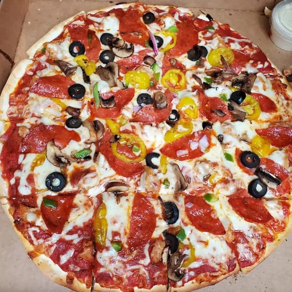 Dontae's Highland Pizza Parlor's pizza, topped with pepperoni, olives, mushrooms, and peppers.